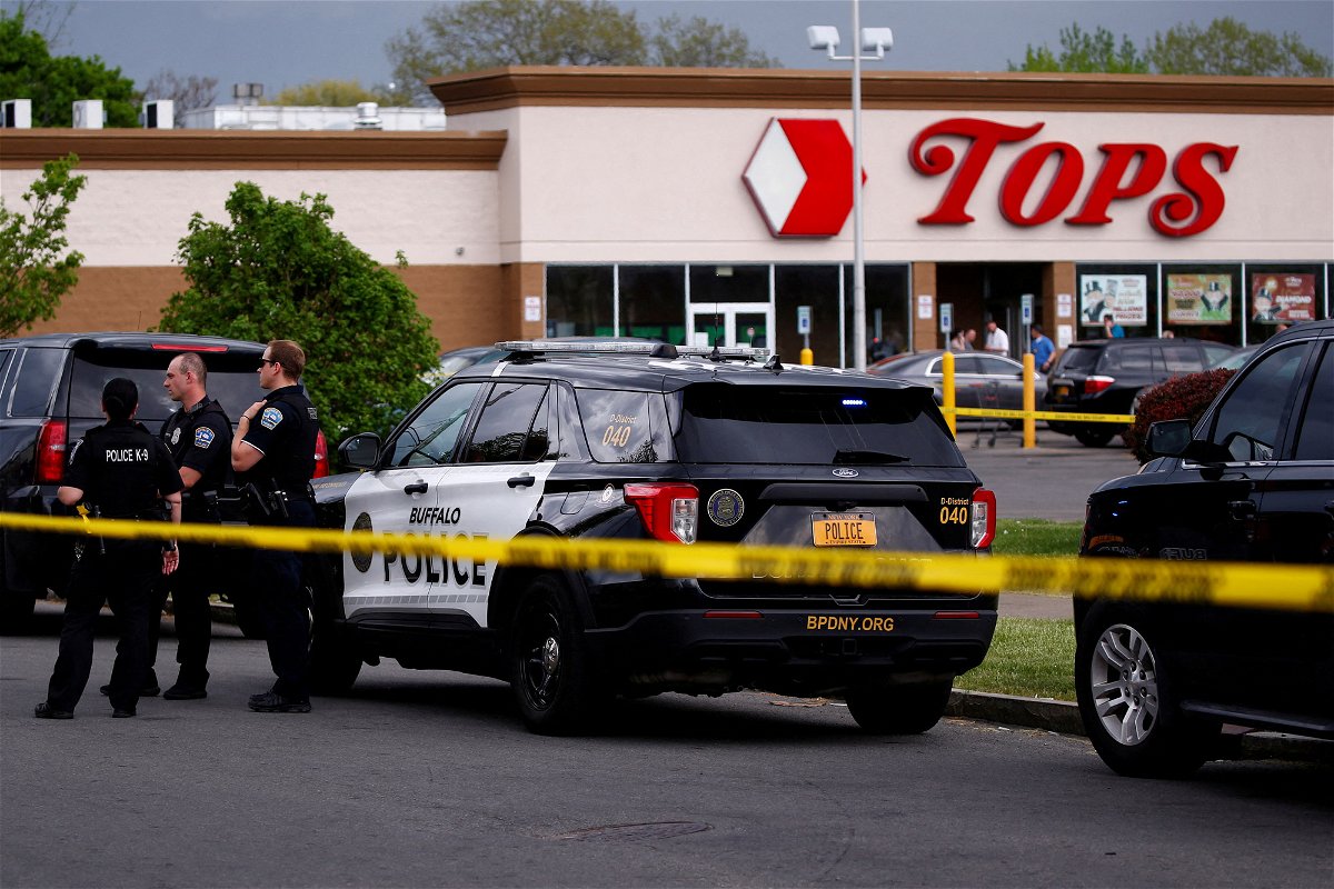 <i>Jeffrey T. Barnes/REUTERS</i><br/>Police officers secure the scene after a shooting at TOPS supermarket in Buffalo