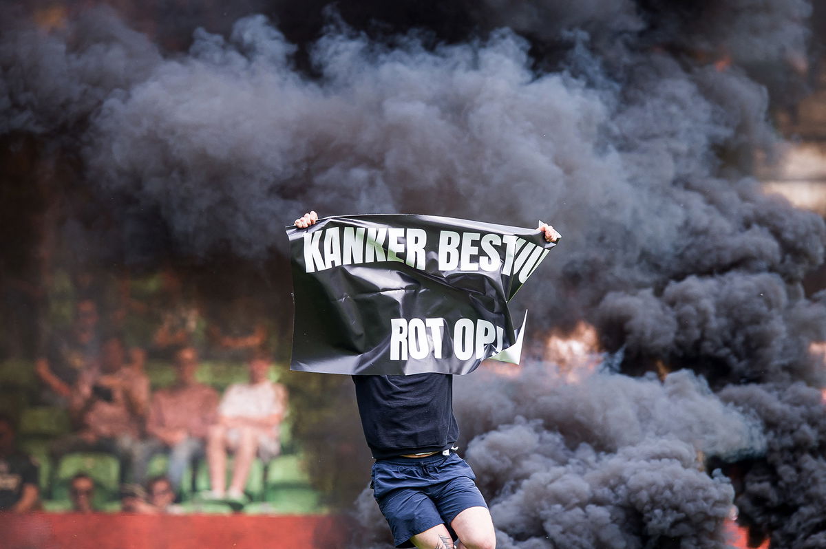 <i>Cor Lasker/ANP/AFP/Getty Images</i><br/>A supporter holding a banner runs onto the pitch at the Euroborg stadium.