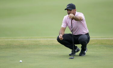 Day lines up a putt during his nine-under final round.