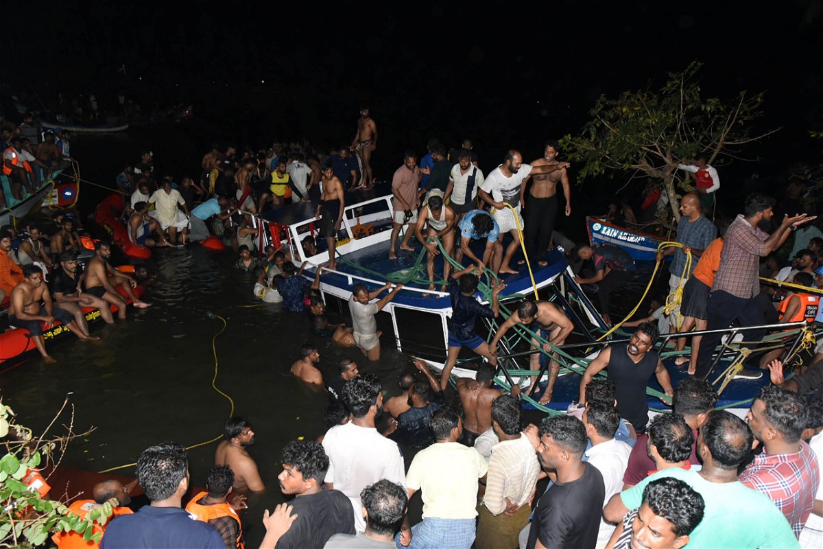 <i>AFP/Getty Images</i><br/>People attempt to rescue trapped tourists at the site of a boat accident in Tanur