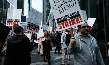 Members of the Writers Guild of America (WGA) East hold signs as they walk in a picket-line outside of HBO and Amazon's offices on May 10. Television and film studios started contract negotiations on Wednesday with the Directors Guild of America.