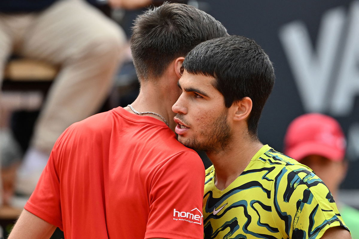 <i>Tiziana Fabi/AFP/Getty Images</i><br/>Marozsán and Alcaraz embrace after their match.