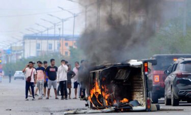 Smoke billows from a vehicle burned during an outbreak of ethnic violence in Imphal