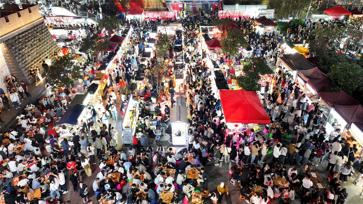 <i>Li Hanchi/Xinhua/Getty Images</i><br/>Tourists visit a night market in Liuzhou