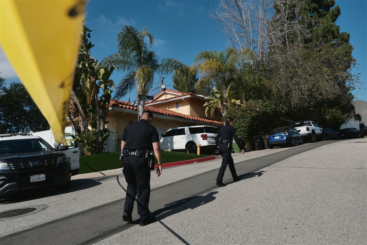 <i>Richard Vogel/AP/FILE</i><br/>Police officers block the street access to a house where three people were killed and four others wounded in a shooting at a short-term rental home in an upscale neighborhood in Los Angeles on January 28.