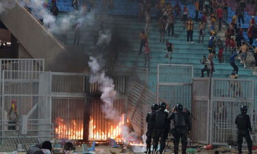 Esperance supporters clash with riot police during the CAF Champions League quarterfinal match between Esperance Sportive de Tunis and JS Kabylie.