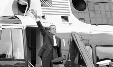 President Richard Nixon waves goodbye from the steps of his helicopter outside the White House
