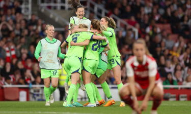 Wolfburg's players celebrate Pauline Bremer's winning goal against Arsenal.