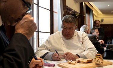 A member of the jury inspects baguettes for the 2023 contest.