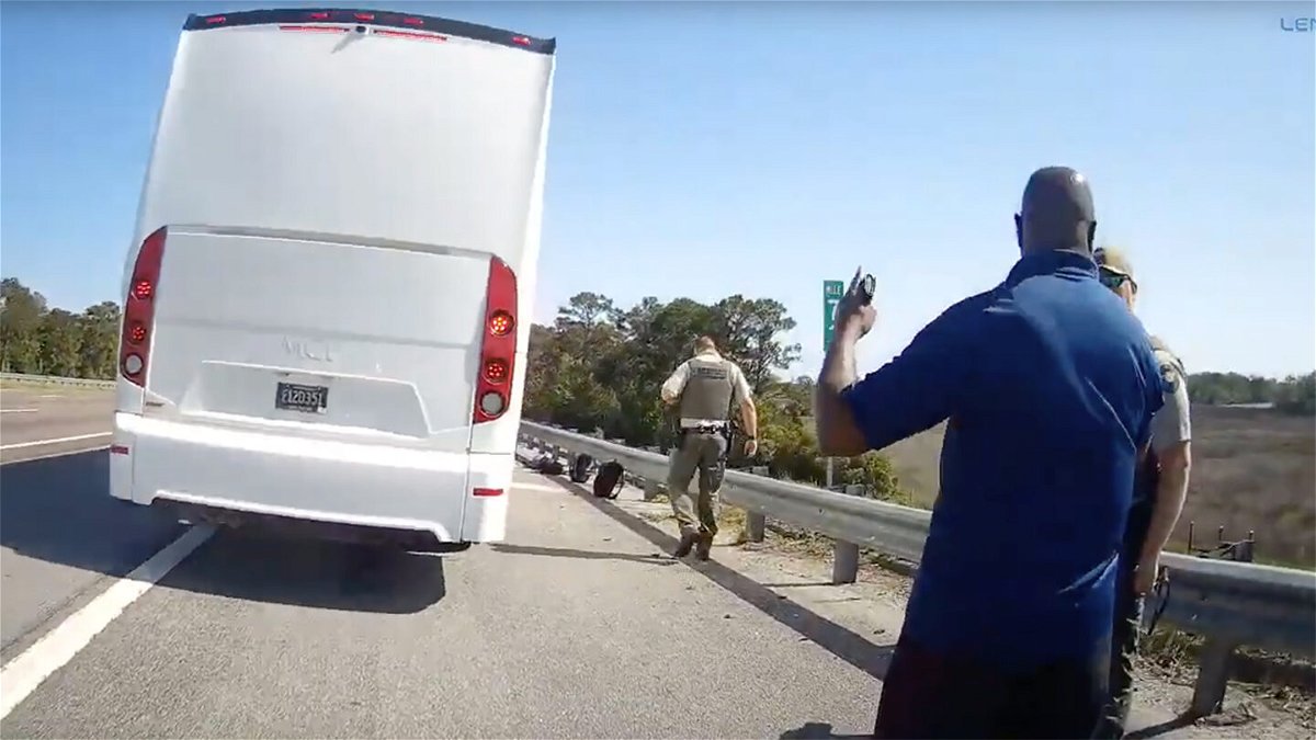 <i>Liberty County Sheriff's Department</i><br/>A still from body camera footage released by the Liberty County Sheriff's Office shows the bus and driver on the side of the highway.