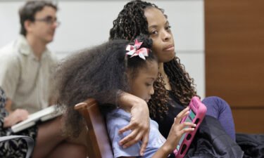 Philana Holmes and her daughter Olivia Caraballo listen to the final witness in their case in Fort Lauderdale