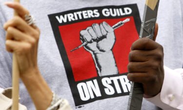 Members of Writers Guild of America hold signs on a picket line in front of Paramount Studios during the 2007 strike that lasted 100 days.
