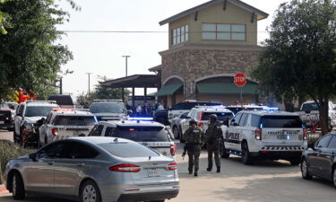 Emergency personnel work the scene of a shooting at Allen Premium Outlets.