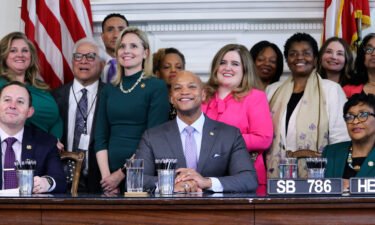 Maryland Gov. Wes Moore and state lawmakers pose for photos at a bill-signing ceremony on May 3 in Annapolis. Moore signed bills into law Wednesday that enshrine abortion rights and protect gender-affirming care.