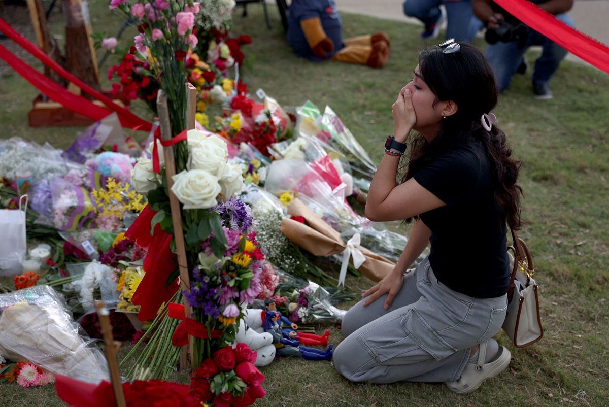 <i>Joe Raedle/Getty Images</i><br/>A mourner at a makeshift memorial at the Allen Premium Outlets on Monday