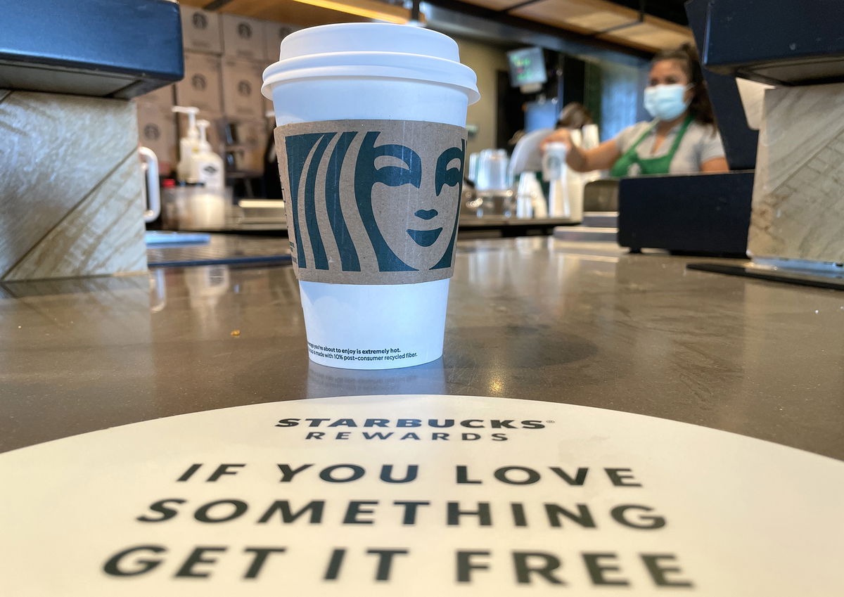 <i>Justin Sullivan/Getty Images/FILE</i><br/>The Starbucks logo is displayed on a cup at a Starbucks store in October 2021 in Marin City