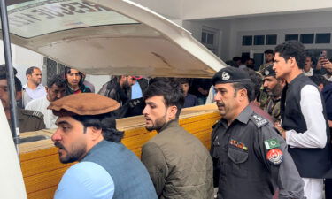 People carry a teacher's dead body into an ambulance after the incident.