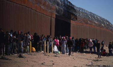 Hundreds of migrants line up to be processed by US Border Patrol under the Stanton Street Bridge after illegally entering the US