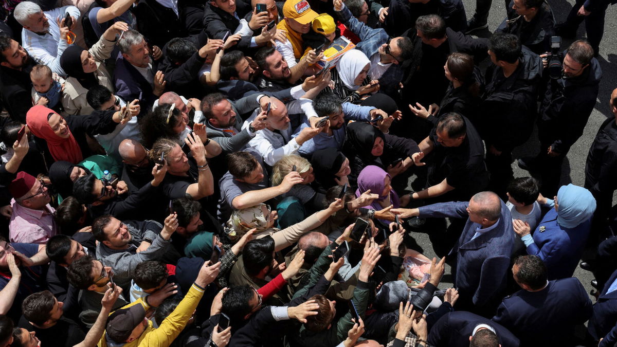 <i>Umit Bektas/Reuters</i><br/>Turkish President Tayyip Erdogan and his wife Emine Erdogan meet supporters outside a polling station in Istanbul