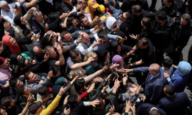Turkish President Tayyip Erdogan and his wife Emine Erdogan meet supporters outside a polling station in Istanbul