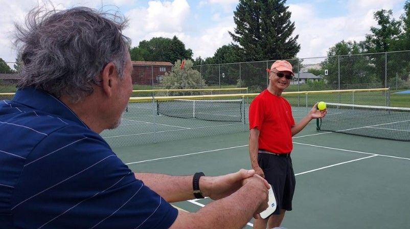 <i></i><br/>An attendee of a veteran pickleball clinic grins at his fellow vet before serving. John Beaudry