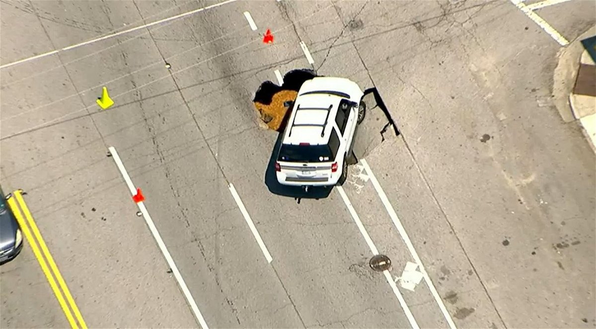 <i></i><br/>A white SUV appears to have fallen into a large sinkhole along Ponce De Leon and Penn Avenue in Atlanta