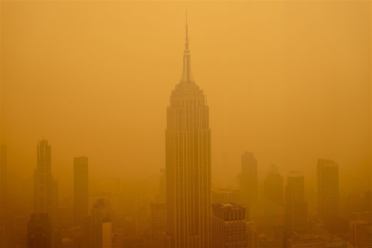 <i>David Dee Delgado/Getty Images</i><br/>Smoky haze from wildfires in Canada diminishes the visibility of the Empire State Building on June 7 in New York City.