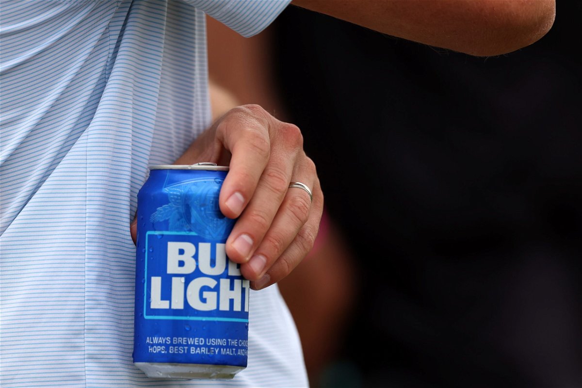 <i>Rob Carr/Getty Images</i><br/>A fan holds a Bud Light beer during day three of the LIV Golf Invitational - DC at Trump National Golf Club on May 28