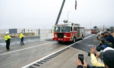 A fire engine from the Philadelphia Fire Department is the first to cross the repaired section of Interstate 95 as the highway is reopened on June 23 in Philadelphia.