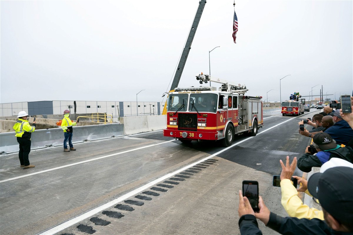<i>Joe Lamberti/AP</i><br/>A fire engine from the Philadelphia Fire Department is the first to cross the repaired section of Interstate 95 as the highway is reopened on June 23 in Philadelphia.