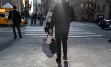 People walk along 5th Avenue in Manhattan