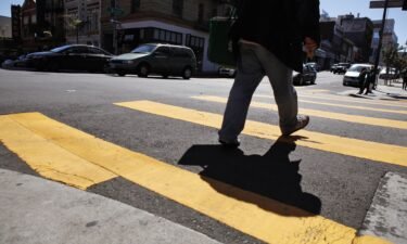 A pedestrian makes his way through the crosswalk at the intersection of Polk Street and Bush Streets in San Francisco on April 23