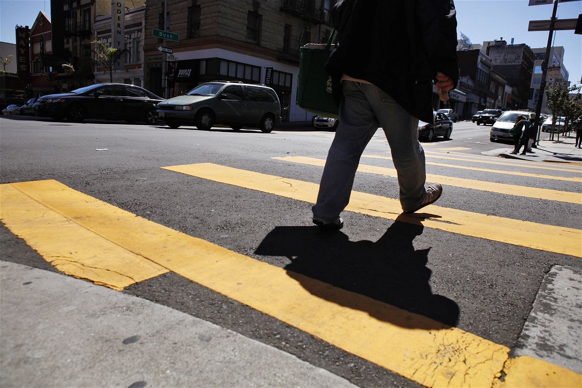 <i>Carlos Avila Gonzalez/The San Francisco Chronicle/Getty Images</i><br/>A pedestrian makes his way through the crosswalk at the intersection of Polk Street and Bush Streets in San Francisco on April 23