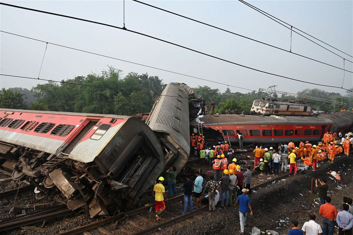 <i>Dibyangshu Sarkar/AFP/Getty Images</i><br/>Rescue workers gather around damaged carriages during search for survivors at the accident site of a three-train collision near Balasore in the eastern state of Odisha