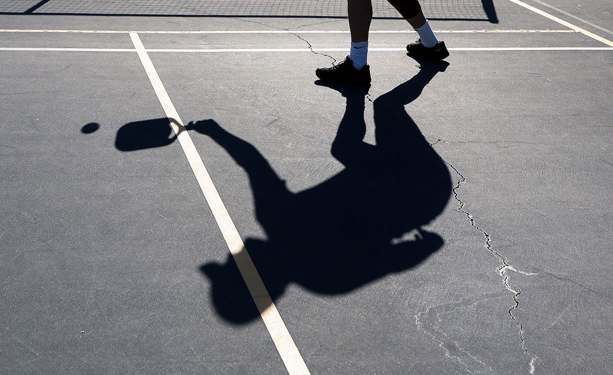 <i>Kevin Dietsch/Getty Images</i><br/>A player's shadow is seen during a game of pickleball on April 12