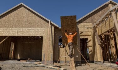 US home building surged in May. A contractor works on a house under construction in Folsom