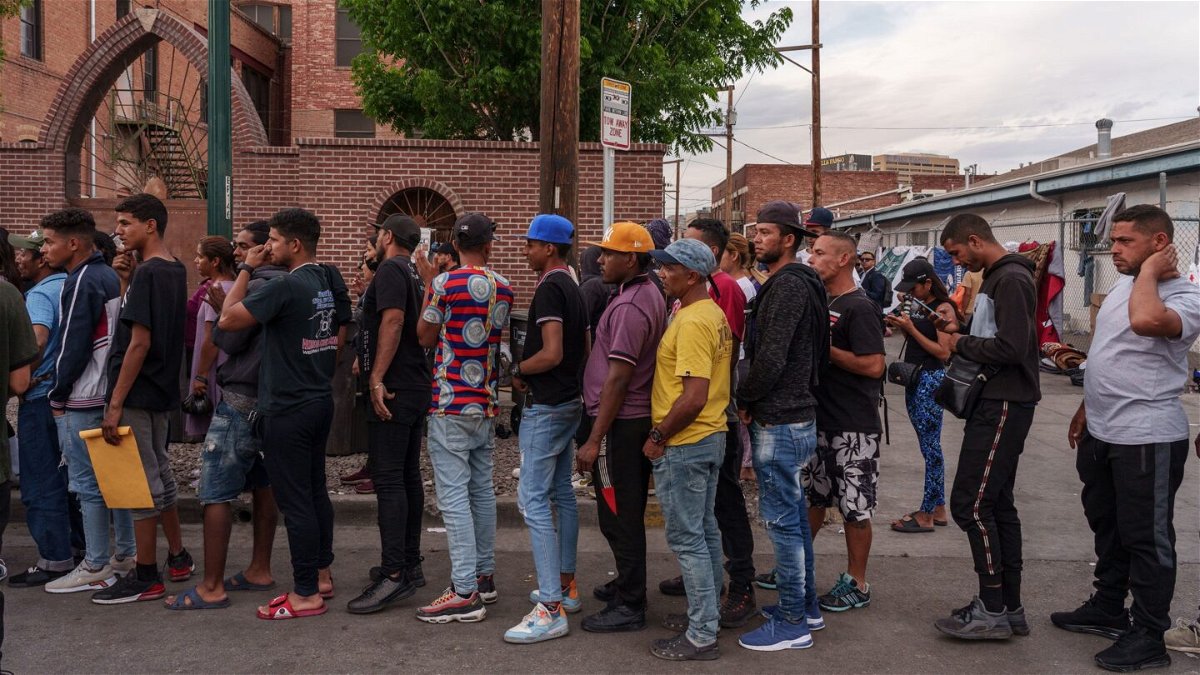 <i>Paul Ratje/Bloomberg/Getty Images</i><br/>Migrants wait in line for donations outside of Sacred Heart Church before the lifting of Title 42 in El Paso