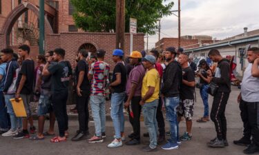 Migrants wait in line for donations outside of Sacred Heart Church before the lifting of Title 42 in El Paso