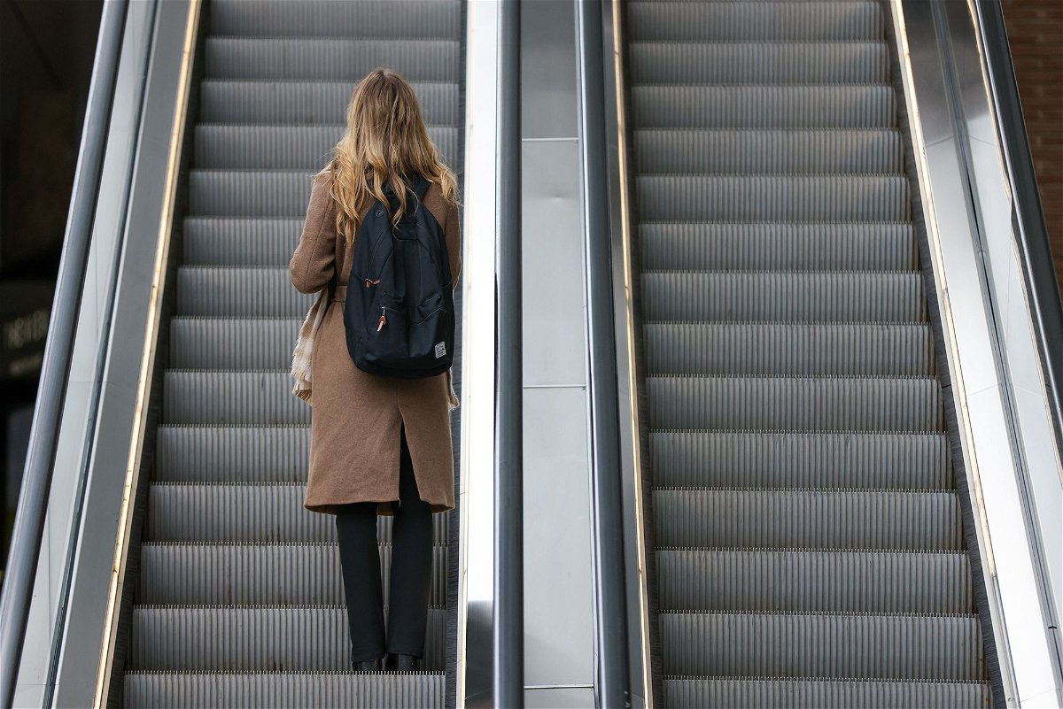<i>Hollie Adams/Bloomberg/Getty Images</i><br/>An office worker rides an escalator at London Bridge railway station in London