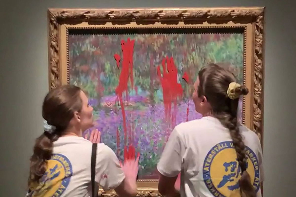 <i>Aterstall Vatmarker/Handout/AFP/Getty Images</i><br/>This handout video grab taken from footage provided by action network Aterstall Vatmarker on June 14 shows two activists smearing paint on the painting 