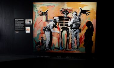 Banksy's 2017 work "Basquiat being stop and searched" pictured on display ahead of the opening of the artist's new exhibition "Cut & Run" at Glasgow's Gallery of Modern Art.