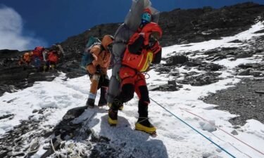 Ngima Tashi Sherpa carries a Malaysian climber while rescuing him from the "death zone" above camp four at Everest.