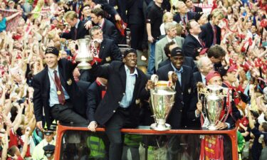 The Manchester United team -- including Cole (front right) -- celebrate winning the treble as they make their way through Manchester during a bus parade.