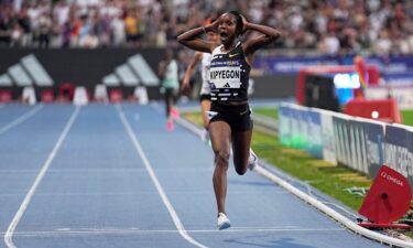 Faith Kipyegon crosses the finish line to win the women's 5