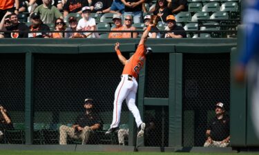 Anthony Santander leaps to make a catch on a fly ball by Kansas City Royals' Maikel Garcia during the first inning.