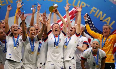 Megan Rapinoe lifts the trophy after the USWNT won the 2019 Women's World Cup.