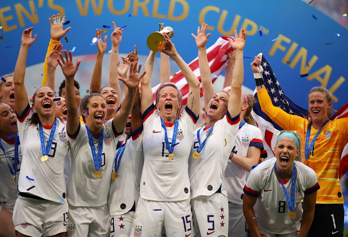 <i>Richard Heathcote/Getty Images</i><br/>Megan Rapinoe lifts the trophy after the USWNT won the 2019 Women's World Cup.