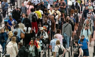 Travelers wait in line at Hartsfield-Jackson Atlanta International Airport on Thursday