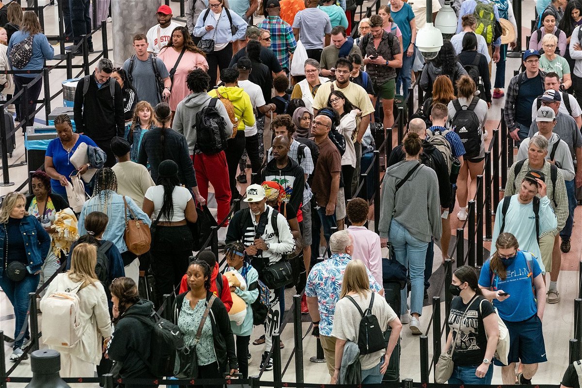 <i>Elijah Nouvelage/Bloomberg/Getty Images</i><br/>Travelers wait in line at Hartsfield-Jackson Atlanta International Airport on Thursday