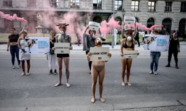 Demonstrators of the animal rights organization PETA hold signs with the inscription "Leather kills" in the air at the Mercedes-Benz Creators Night of the Mercedes-Benz Fashion Week at the Telegraphenamt on the occasion of the Berlin Fashion Week.